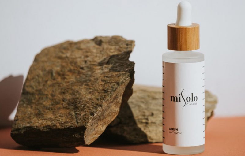 Elegantly crafted skincare serum with a natural rock background, perfect for beauty and wellness themes.